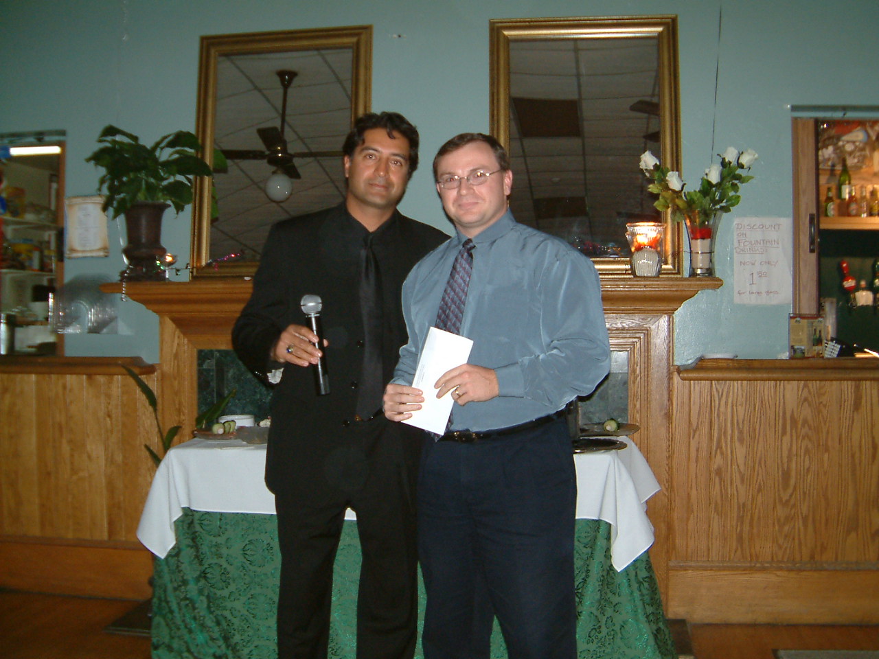 Imran presenting a cheque to Michel from Search and Rescue in 2004.